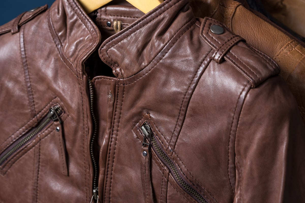 Brown textured leather jacket. Leather jacket macro details. Jacket zippers and pockets